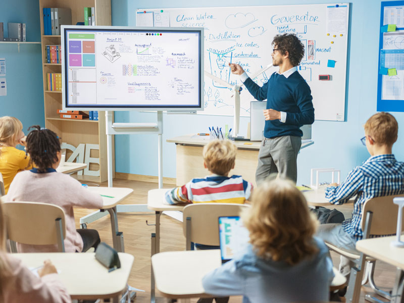 Teacher pointing at whiteboard